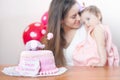 Mother with funny baby celebrating first birthday. Cake. Royalty Free Stock Photo