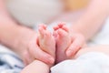 Mother gently hold baby leg Royalty Free Stock Photo