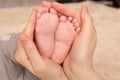 Mother gently hold baby leg in hand Royalty Free Stock Photo