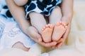 Mother gently hold baby leg in hand. soft focus on babies foot Royalty Free Stock Photo