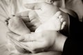 Mother gently holding the feet of her baby Royalty Free Stock Photo