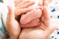 Mother gently holds baby legs in hands. Royalty Free Stock Photo
