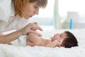 Mother gently massaging her baby`s feet Royalty Free Stock Photo