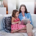 Mother, girl child and relax with tablet for streaming, elearning or online games with bonding or together at family Royalty Free Stock Photo