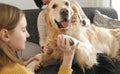 Mother and girl daughter playing with golden retriever Royalty Free Stock Photo