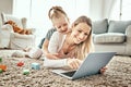 Mother, girl and laptop for home games, e learning and funny video streaming or education on carpet in living room Royalty Free Stock Photo