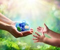 Mother Give Blue Earth In Daughter Hands Royalty Free Stock Photo