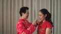 Mother give gift jad necklace to daughter on Chinese New Year