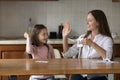 Mother give high five to daughter praising for multiplication success