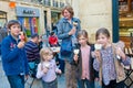 Mother and four kids enjoy ice cream. Happy mother, boy and three girls eating ice cream in Bordeaux, France