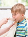 Mother gives to drink to the sick child