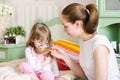 Mother gives to drink to the sick child