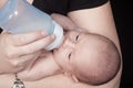 Mother giving baby bottle Royalty Free Stock Photo