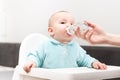 Mother Giving Baby To Drink Water From Bottle Royalty Free Stock Photo