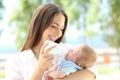 Mother giving bottle feeding to her baby