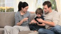 Mother giving cakes to her son and husband