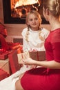 Mother giving daughter Christmas present Royalty Free Stock Photo