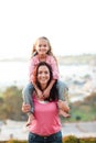 Mother giving her daughter piggyback Royalty Free Stock Photo