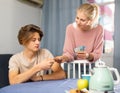 Mother giving some cash her teenager son Royalty Free Stock Photo