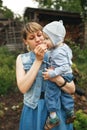 Mother giving son strawberries to taste. Beautiful mother feeding her baby boy. Royalty Free Stock Photo