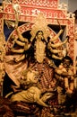 Mother Goddess devi with bow and arrows, conch shell, sword, shield and lion in durga puja or durga ashtami