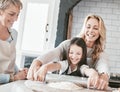 .Mother, grandmother and child cooking and baking with rolling pin for pastry, pie or pizza together in family kitchen Royalty Free Stock Photo
