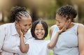 Mother, grandmother and child in garden, happy family sitting on grass, generations at picnic in park. Black family Royalty Free Stock Photo