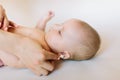 Mother hand cleaning baby ear on towel Royalty Free Stock Photo