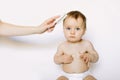 Mother hand is combing baby hair after bathing. Hygiene and care concept Royalty Free Stock Photo