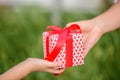 Mother hand giving a gift box to her child. Holidays, present, Royalty Free Stock Photo