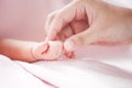 Mother hand holding asian newborn baby girl hand Royalty Free Stock Photo