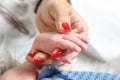 mother hand holding baby boy little cute hand macro focus closeup sweet caring concept