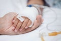 Mother hand holding child hand who have IV solution