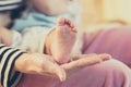 Mother hand holding feet baby child with careful. Royalty Free Stock Photo