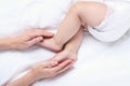 Mother hand holding her baby legs Royalty Free Stock Photo