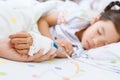 Mother hand holding sick daughter hand who have IV solution Royalty Free Stock Photo