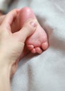 Mother hand massaging baby foot on