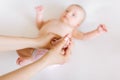 Mother hand massaging foot of her baby on white background Royalty Free Stock Photo