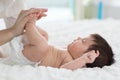 Mother hand massaging foot of her baby,