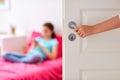 Mother hand opening door to girl room Royalty Free Stock Photo