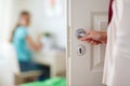 Mother hand opening door to girl room Royalty Free Stock Photo