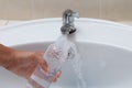 Mother hand washing baby milk bottle on white sink Royalty Free Stock Photo