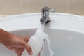 Mother hand washing baby milk bottle on white sink Royalty Free Stock Photo