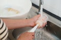 mother hand washing baby plastic milk bottle Royalty Free Stock Photo