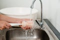 mother hand washing baby plastic milk bottle Royalty Free Stock Photo