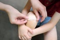 Mother hands applying antibacterial medical adhesive plaster on child`s knee after falling down