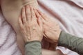 Mother hands applying cream on baby after bathing in room. hands of a mother massaging her baby`s feet, in bed at home Royalty Free Stock Photo