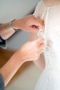 Mother hands buttoning wedding dress Royalty Free Stock Photo