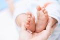 Mother hands holding tiny baby feet Royalty Free Stock Photo