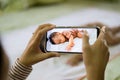 Mother hand taking a picture to baby boy with smart phone,Family memory concept,Close up Royalty Free Stock Photo
